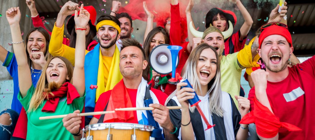 Football supporters at the stadium - Football fans having fun and looking at football match